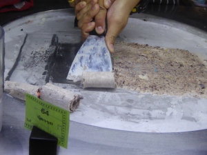 Then the mixture is spread out on a cold plate to freeze, and rolls of it are created using the spatula once it's frozen